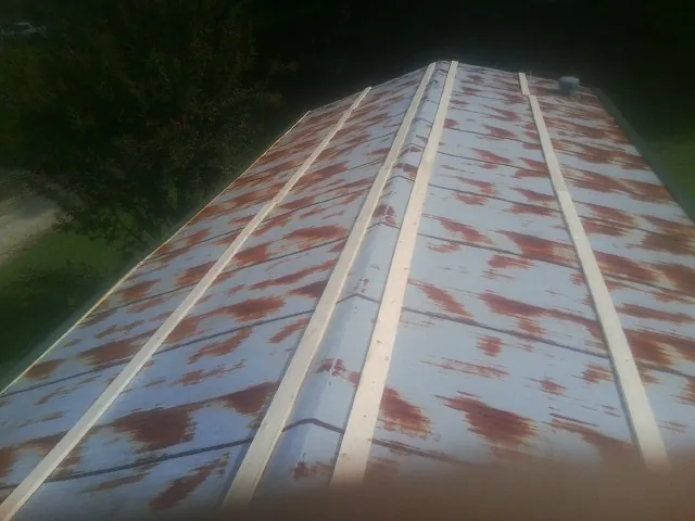 Rusted metal roof panels with new wood purlins before replacement — Storm Damage Roof Repair in California by Roofing Brothers